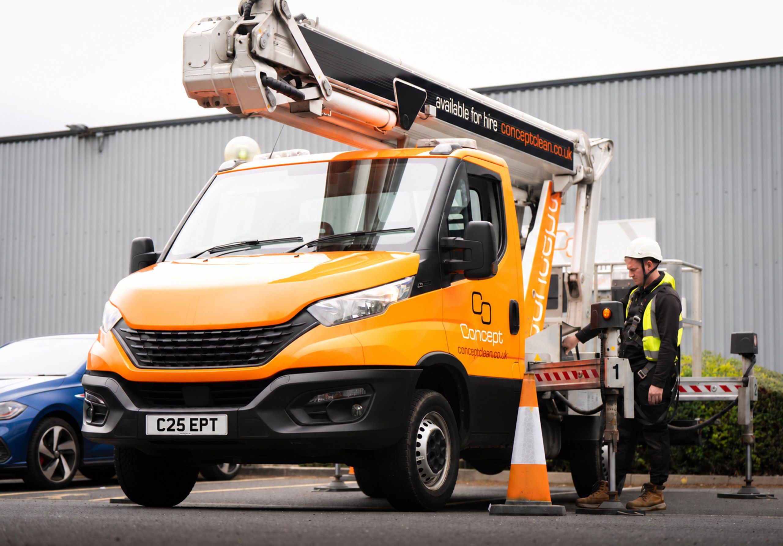 Concept Clean’s orange cherry picker and operator at a commercial site